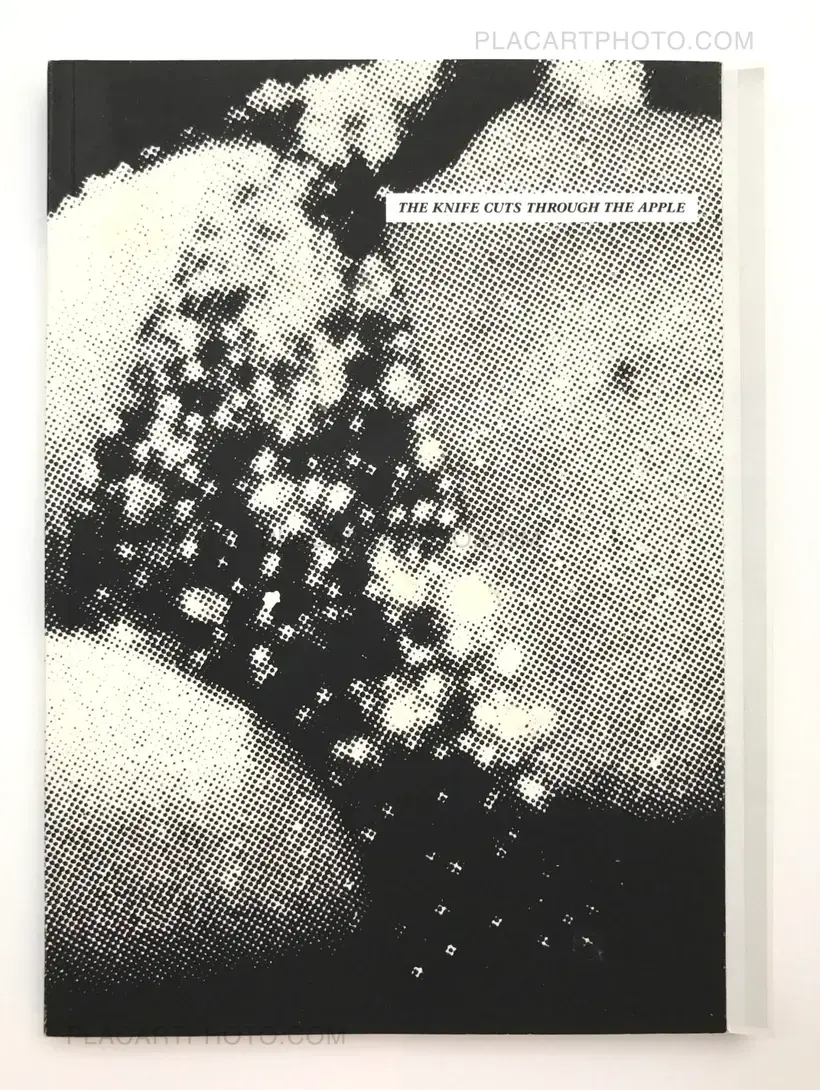 The knife cuts through the apple like a knife cutting an apple (SIGNED)